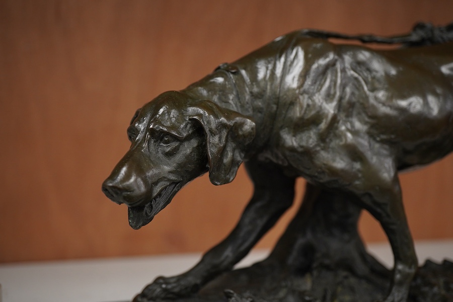 A patinated bronze of a hunting dog, signed Coreira, on black marble base, 36cm wide
